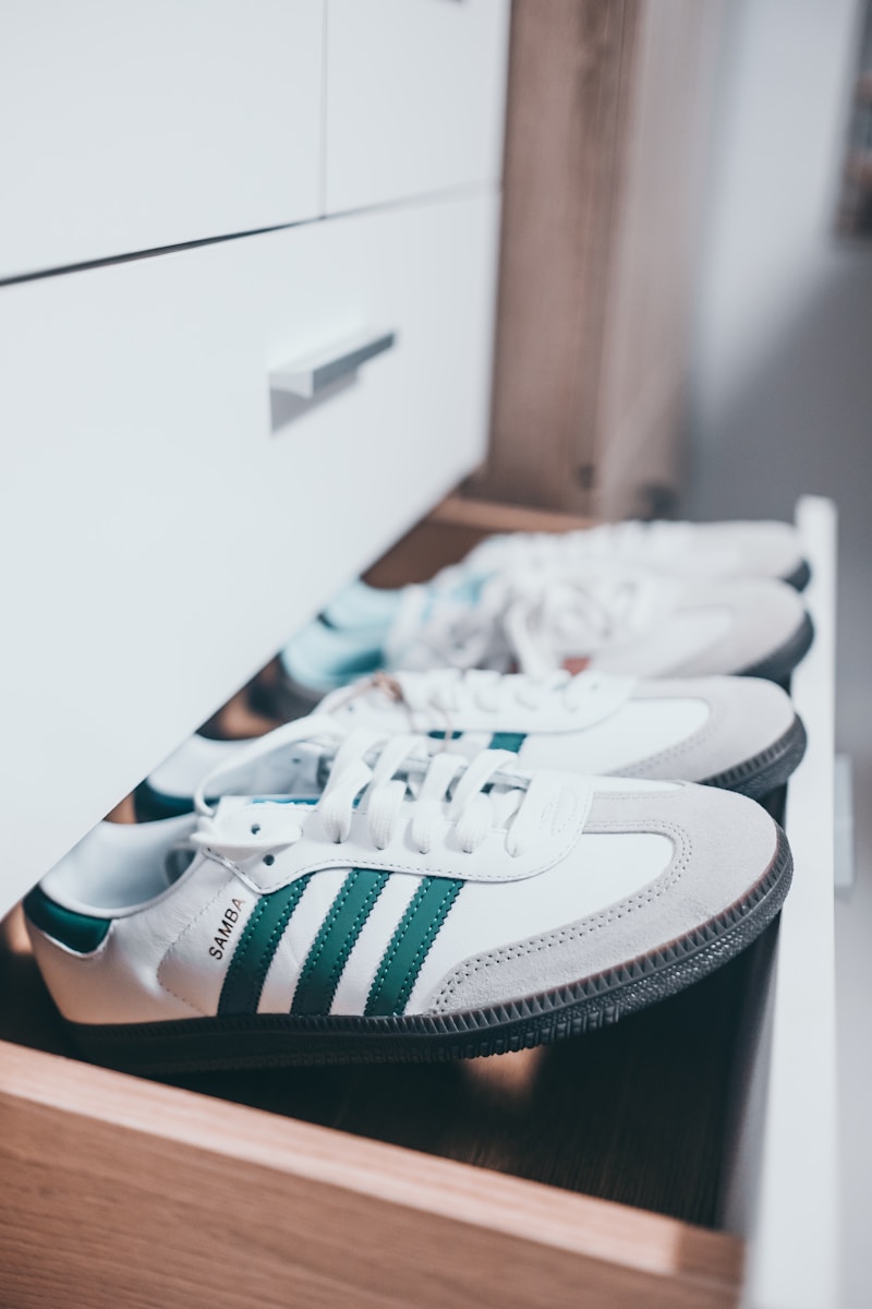 Photo by SJ 📸 a row of white and green adidas sneakers